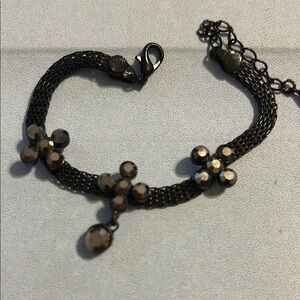 Mesh type bracelet with flower type embellishments